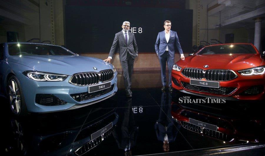 Head of Corporate Communicatios of BMW Group Malaysia, Sashi Ambi (left) and Managing Director of BMW Group Malaysia, Harald Hoelzl pose with BMW The 8 during launch at The Kuala Lumpur and Selangor Chinese Assembly Hall. NSTP/NURUL SHAFINA JEMENON