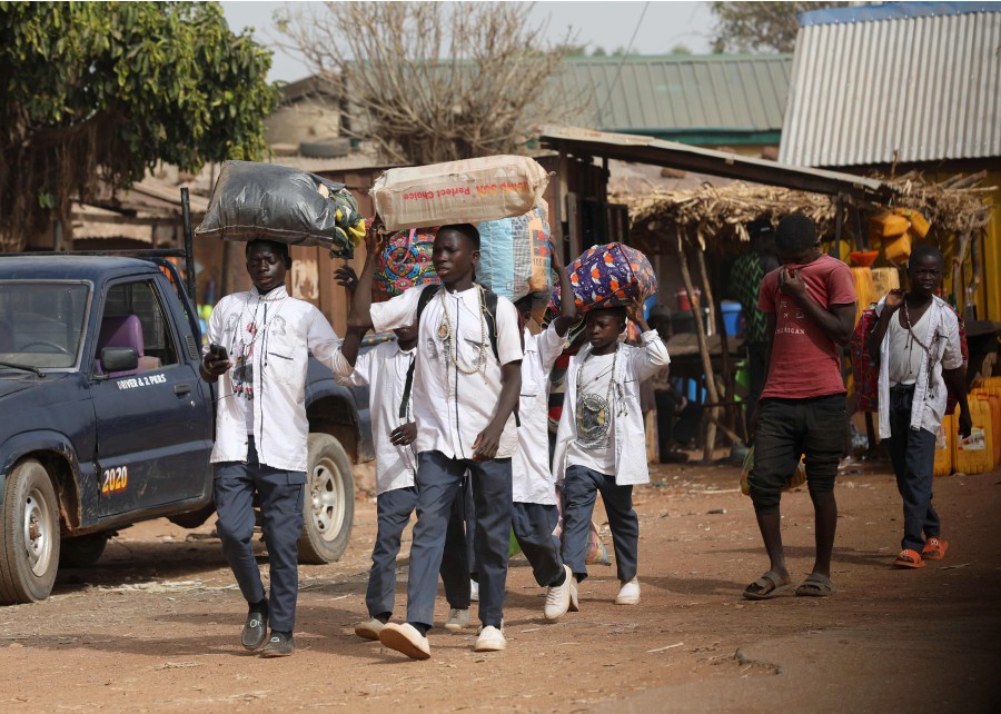 Boarding school children return home due to the abduction of students kidnapped by gunmen at the Government Science Secondary school, in Kankara, Nigeria. - AFP pic