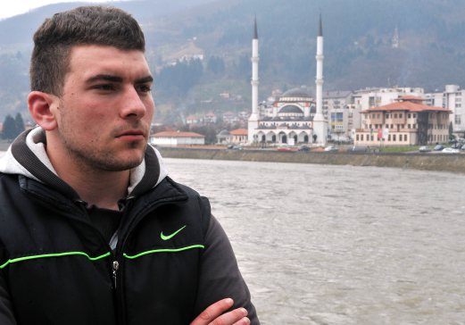 22-year-old Bosnian Alen Muhic poses during an interview in Gorazde on March 27, 2015, after the premierre of the documentary film "An Invisible Child's Trap". Alen Muhic, abandoned at birth by his Muslim mother who was raped by a Serb soldier during Bosnia's 1990s war, 22 years later launched a quest for his biological parents. His painful and dramatic search was presented in a touching documentary filmed to break a taboo of those "invisible children" of conflicts and that had its premiere here earlier this month. AFP PHOTO 