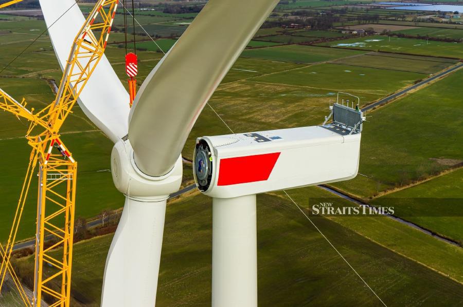 Wind turbine during installation of the star with rotor blades Aerial photograph and close-up view.