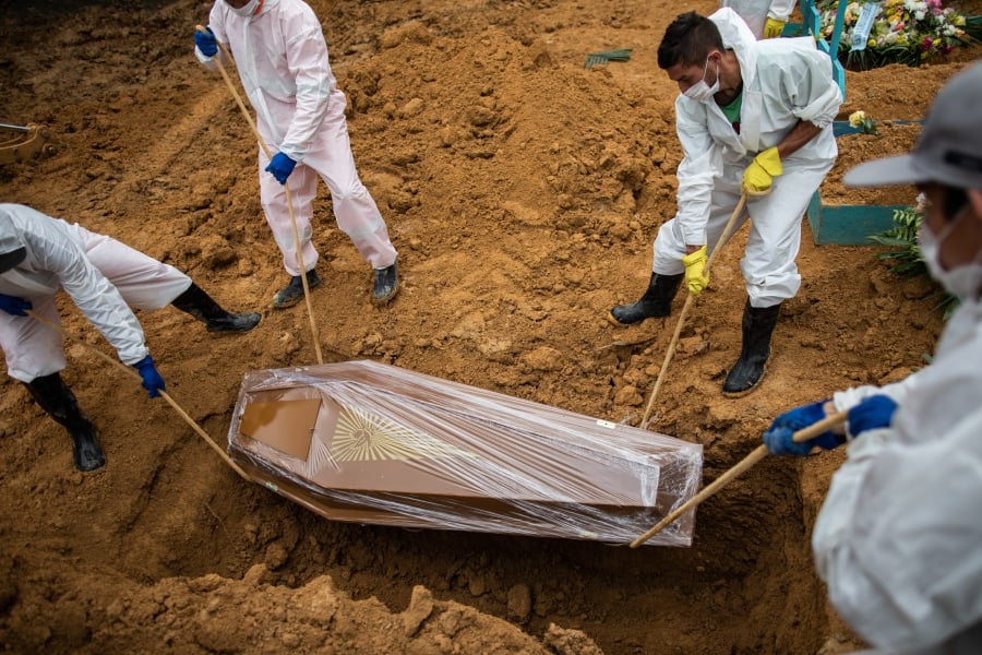 Workers bury a Covid-19 victim at the Nossa Senhora Aparecida Cemetery, in Manaus, Amazonas, Brazil. Brazil is experiencing the worst moment of the coronavirus pandemic, with an explosion of cases that has led health authorities to demand more restriction measures throughout the country, while the President, Jair Bolsonaro, insists on denying the seriousness of a disease that already leaves more than 250,000 dead. EPA/RAPHAEL ALVES