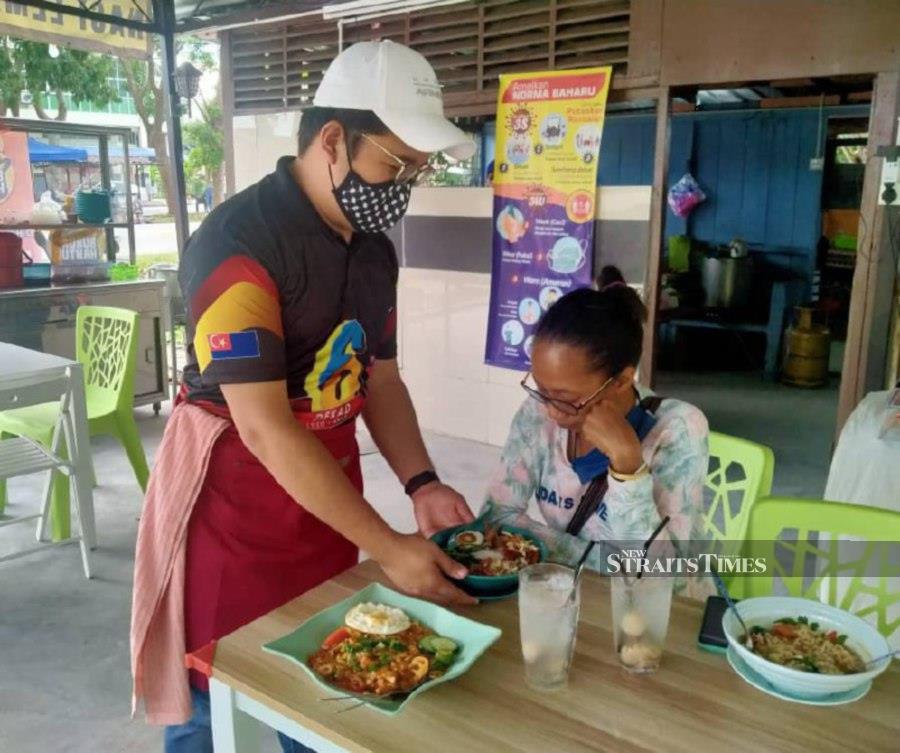 A customer gets a bowl of Bubur Hantu at the stall. - Pic by Zainal Aziz 