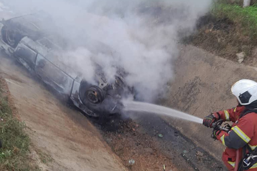 Four people were burnt to death and one person suffered serious injuries when the car they were travelling in caught fire. - Pics courtesy of Fire & Rescue Dept