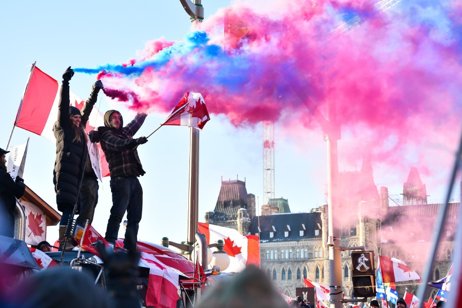 Protesters release smoke flares on February 5, 2022 in Ottawa, Canada.  - AFP PIC