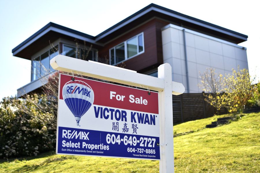 A "For Sale" sign is displayed outside a home in Vancouver, British Columbia, Canada, on Thursday, April 16, 2020. As its oil sector shriveled in recent years, Canada's economy became ever more driven by real estate, an industry now in a state of paralysis while its households are among the world's most indebted, poorly placed to weather the storm. Photographer: Jennifer Gauthier/Bloomberg