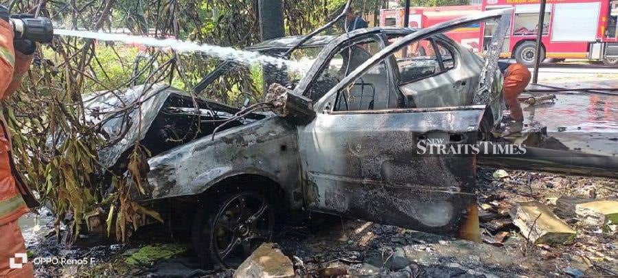 A Proton Persona suspected of carrying fuel was destroyed in a fire after it crashed along Jalan Tanah Merah-Jeli here earlier Friday morning.- Courtesy pic bomba