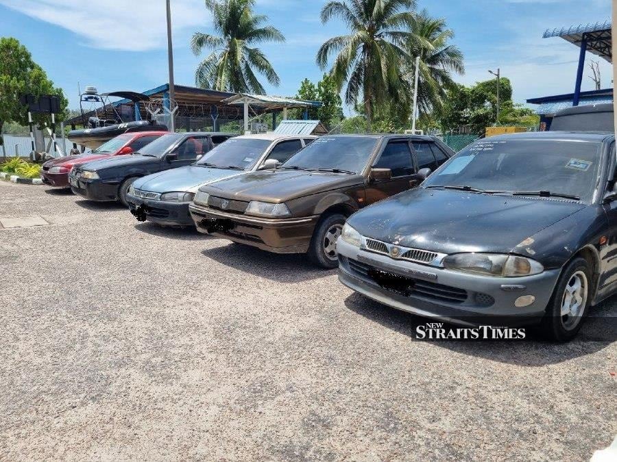 Some of the sedans used by smugglers to send RON95 to a neighbouring country which was seized by the state Domestic Trade and Consumer Affairs ministry recently. -- NSTP/SHARIFAH MAHSINAH ABDULLAH 