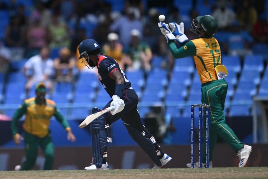 South Africa's Quinton de Kock (R) celebrates catching out USA's Aaron Jones during the ICC men's Twenty20 World Cup 2024 Super Eight cricket match between the United States and South Africa at Sir Vivian Richards Stadium in North Sound, Antigua and Barbuda on June 19, 2024. -- AFP
