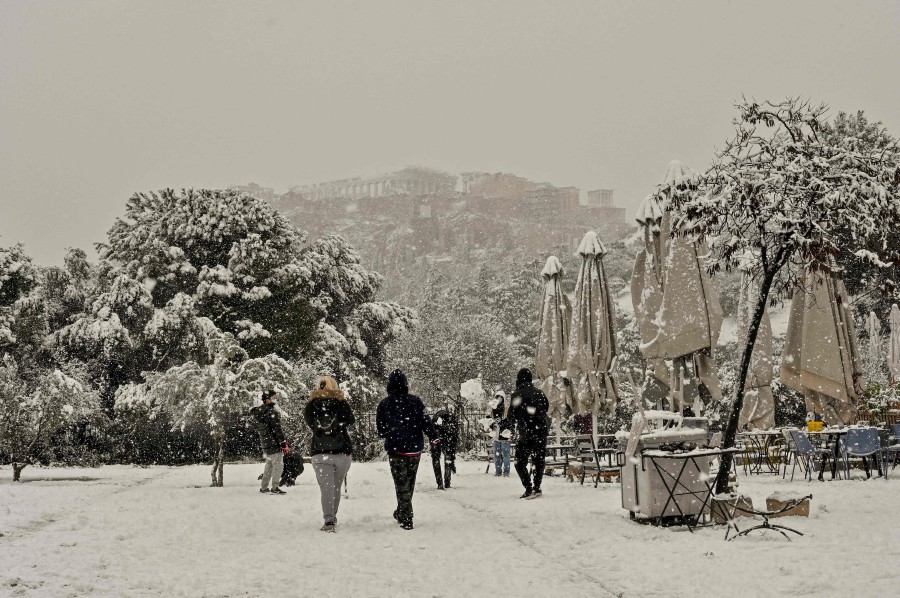 People play with snow in central Athens, during heavy snowfall on January 24, 2022. - AFP PIC