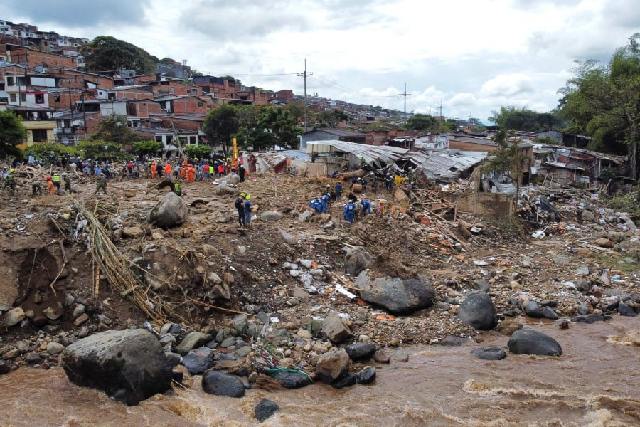 Aerial view of rescuers removing debris during the search of victims after a landslide caused by heavy rains in Pereira, Risaralda department, Colombia. - AFP PIC