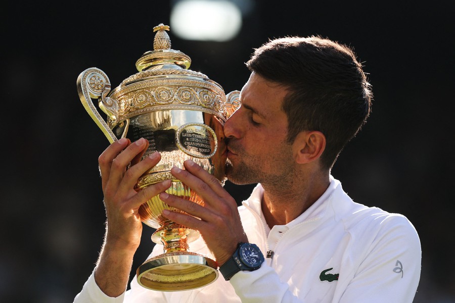 Serbia's Novak Djokovic kisses his trophy after defeating Australia's Nick Kyrgios during the men's singles final tennis match on the fourteenth day of the 2022 Wimbledon Championships at The All England Tennis Club in Wimbledon, southwest London, on July 10, 2022. -- Pic: AFP