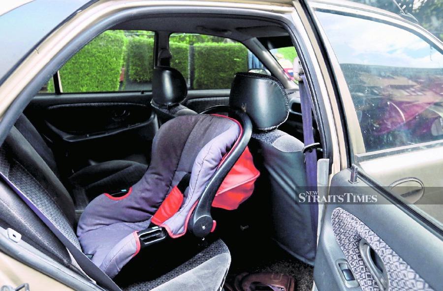 A child safety seat fixed to a car. Employers should have more flexible working conditions to ensure employees do not neglect their caregiving duties. - File pic