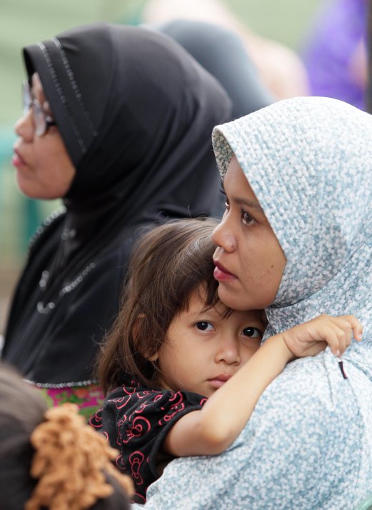 Zaharultul Muna M. Nasir 8, hugs her mother, Nurlaila Ibrahim as they gather at a relief centre in Pidie Jaya, Aceh. pix by AIZUDDIN SAAD.