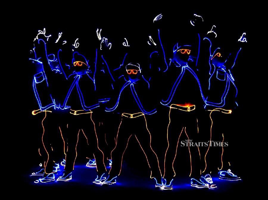 A mix crew from Russia and Ukraine, showing their unique LED show with illuminated costumes.