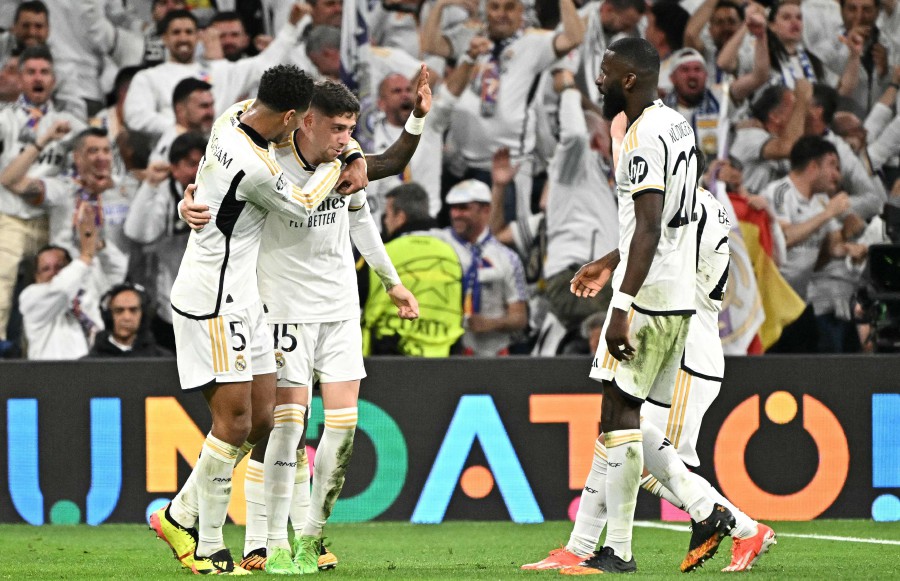 Real Madrid's Uruguayan midfielder #15 Federico Valverde (C) celebrates scoring his team's third goal with teammates during the UEFA Champions League quarter final first leg football match between Real Madrid CF and Manchester City at the Santiago Bernabeu stadium in Madrid on April 9, 2024. AFP PIC