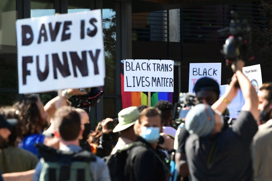 People rally in support of the Netflix transgender walkout and others in support of comedy and free speech, in Los Angeles, California. - AFP PIC