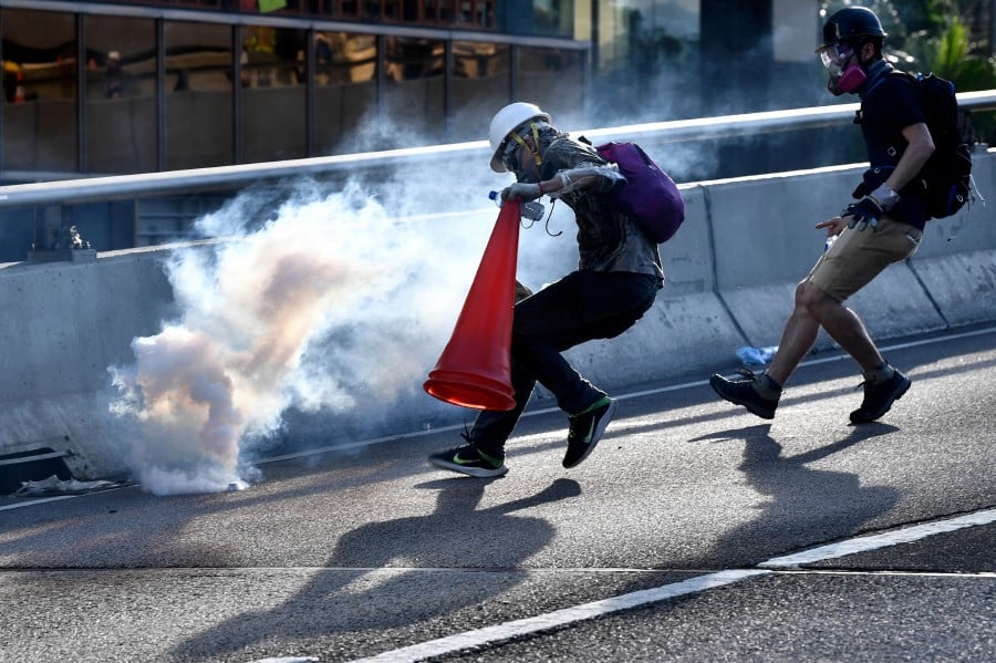 Hong Kongers harness traffic cones, kitchenware to battle tear gas ...