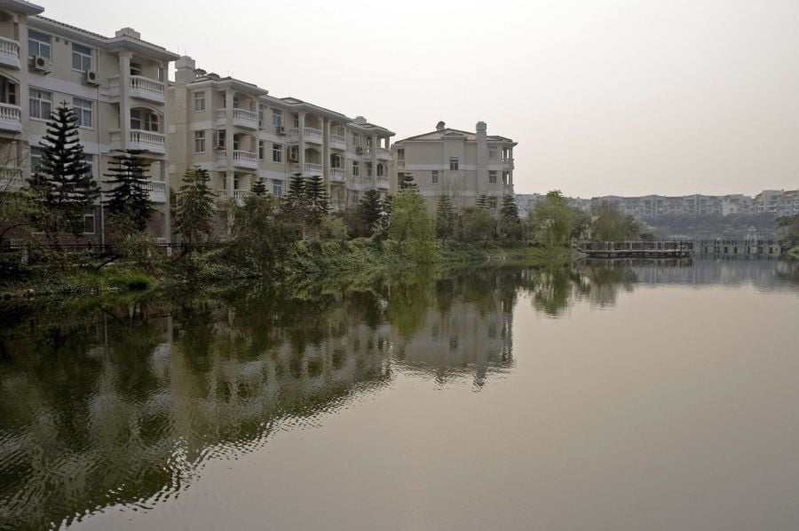 Residential properties line the edge of a lake inside Phoenix City, a property owned by Country Garden Holdings Co., in Guangzhou, China. Photographer: MICHAEL LASSMAN/Bloomberg