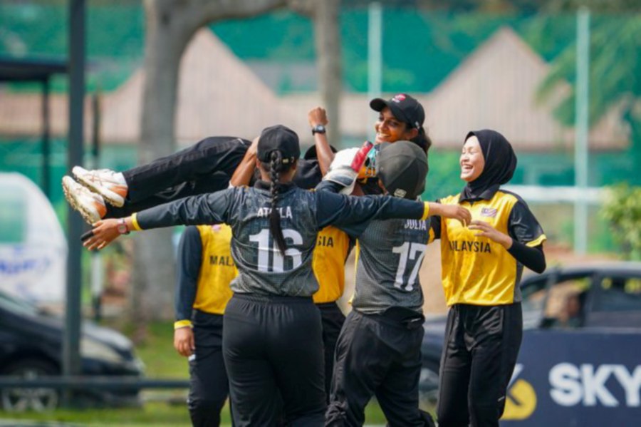 Winifred Durasingam is lifted into the air as Malaysia celebrate taking a Qatar wicket in a Group A match of the ACC Women's T20 Championship at UKM Oval in Bangi yesterday. - Pic courtesy of Malaysian Cricket Association