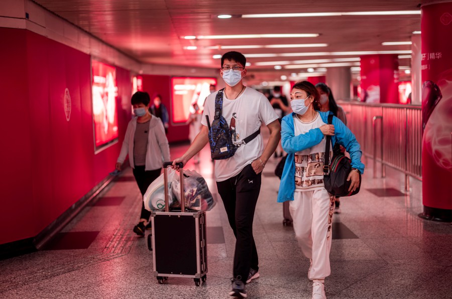 People enter from the subway station to the Pudong International Airport in Shanghai. - EPA PIC