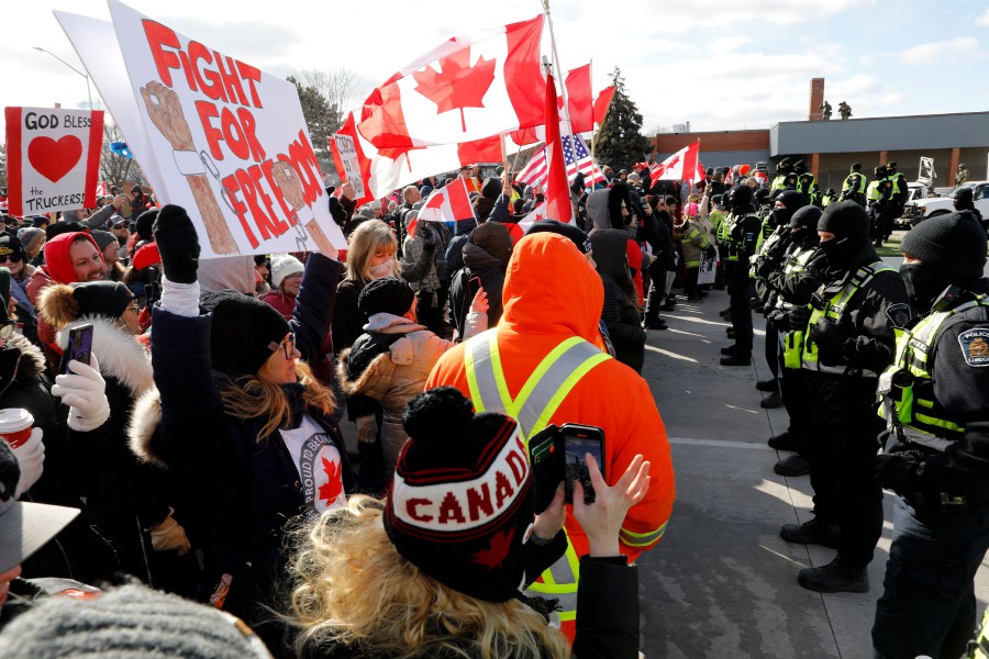 Protestors confront the Ontario Provincial Police as they try to clear the entrance to the Ambassador Bridge in Windsor, Ontario, Canada. - AFP PIC