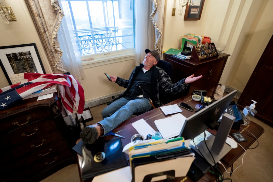  A supporter of US President Donald J. Trump sits on the desk of US House Speaker Nancy Pelosi, after supporters of US President Donald J. Trump breached the US Capitol security in Washington, DC. -EPA pic