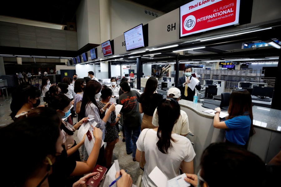 Airline staff conduct drill check-in protocols for tourists during a media preview of airport preparations ahead of the country's reopening, at Don Mueang International Airport in Bangkok, Thailand. - EPA PIC