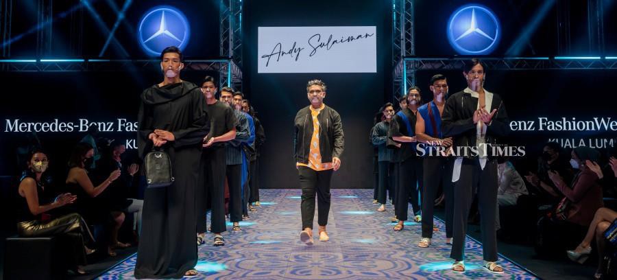 Andy Sulaiman with models in his designs at the Mercedes-Benz Fashion Week Kuala Lumpur. Credit: Daren Chong