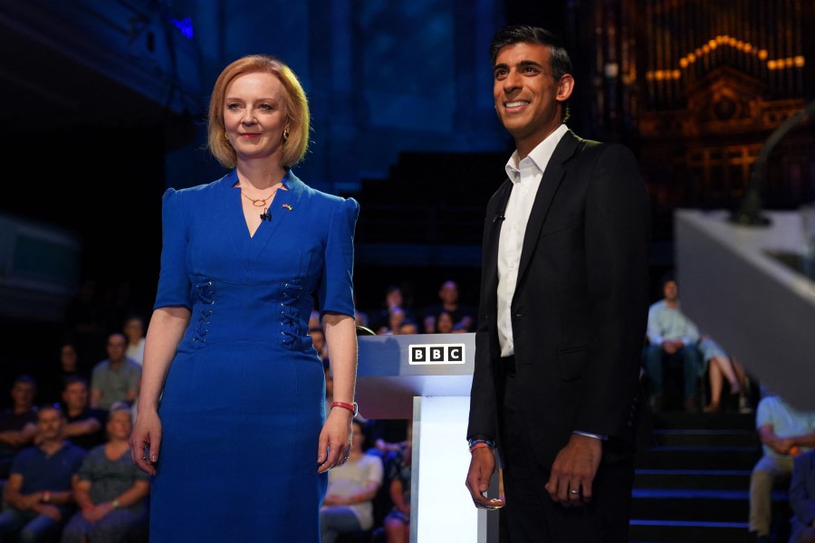 Britain's Foreign Secretary Liz Truss (L) and former chancellor to the exchequer Rishi Sunak, contenders to become the country's next prime minister, arrive to take part in the BBC's 'The UK's Next Prime Minister: The Debate' in Victoria Hall in Stoke-on-Trent, central England. - AFP PIC