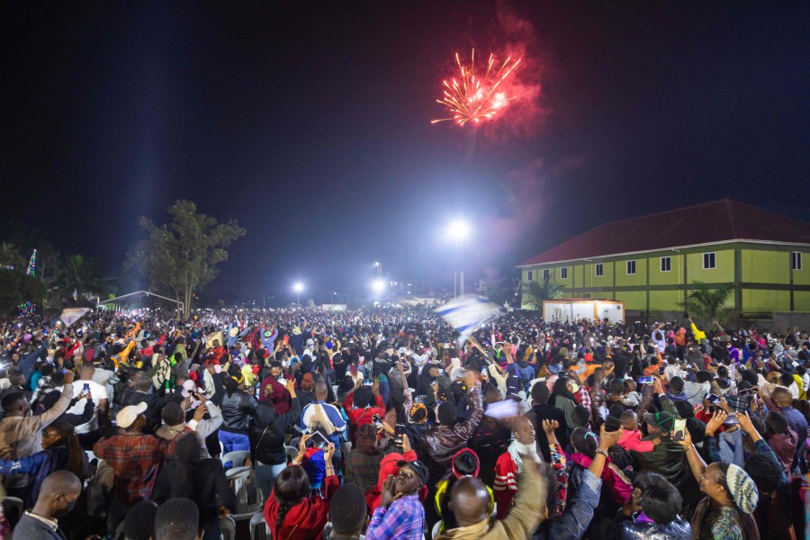 Fireworks light up the sky as people react while they celebrate after counting down to the new year at Miracle Center Cathedral in Kampala, Uganda. - AFP PIC