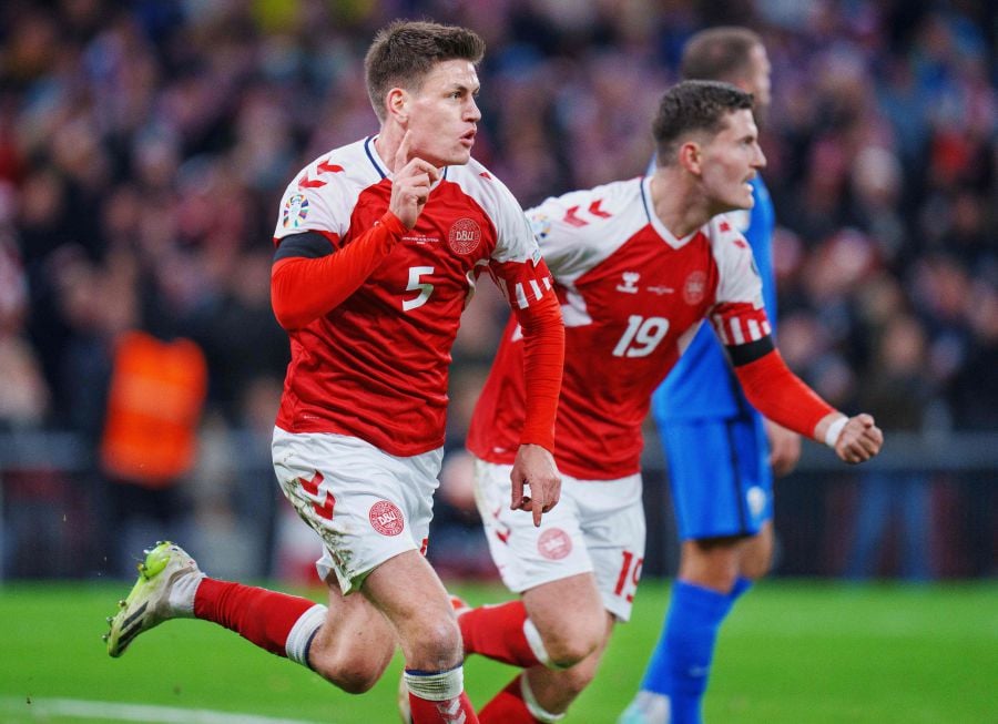 Denmark's defender Joakim Maehle (left) celebrates scoring the opening goal with his teammate Denmark's forward Jonas Wind during the UEFA Euro 2024 Group H qualification football match between Denmark and Slovenia in Copenhagen on November 17, 2023. - AFP pic