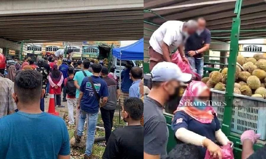 A large crowd gathered to receive the free durian at Jalan Temenggong-Jalan Sekolah in Parit Buntar. - Pic courtesy of NST reader