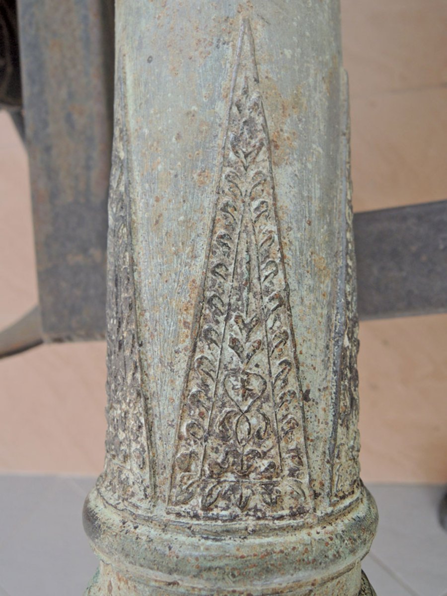 A close-up view of a Malay cannon showing floral designs.