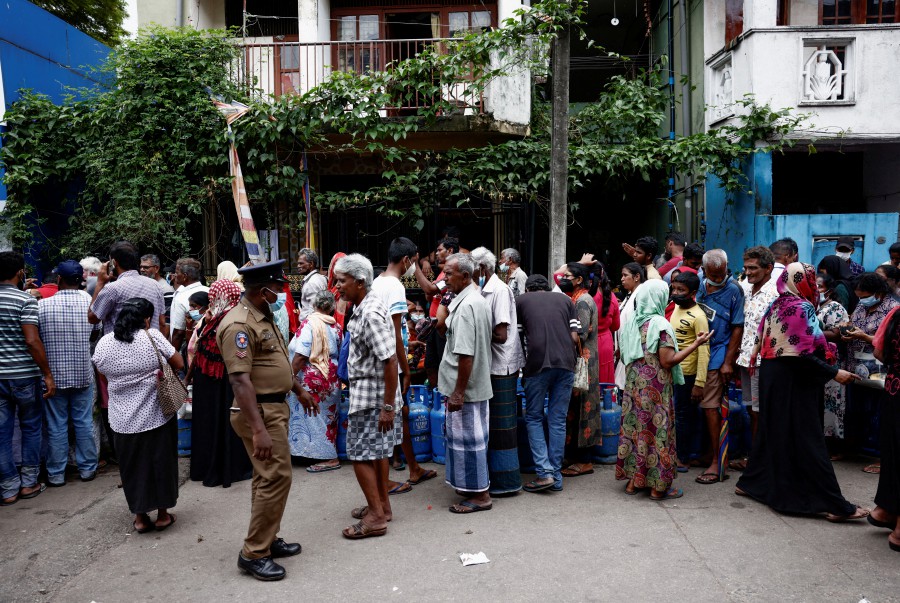 People stand in line to buy domestic gas tanks near a distributor, amid the country's economic crisis, in Colombo, Sri Lanka. - REUTERS PIC