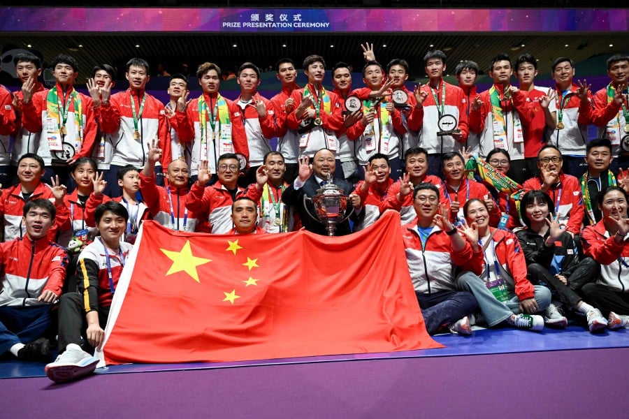 Members of Chinese men’s badminton team pose for a picture with the trophy after their victory over Indonesia in the men’s finals of the Thomas and Uber Cup badminton tournament in Chengdu, in China’s southwest Sichuan province on May 5, 2024. -- AFP