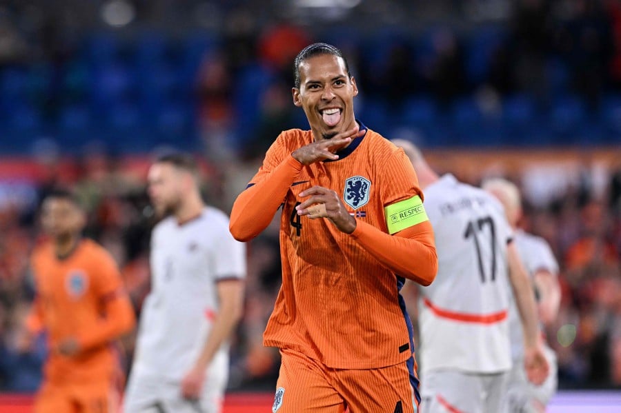 Netherlands' defender #04 Virgil van Dijk (C) celebrates after scoring his teams second goal during the International friendly football match between Netherlands and Iceland at the Feyenoord Stadium, in Rotterdam, on June 10, 2024. -- AFP