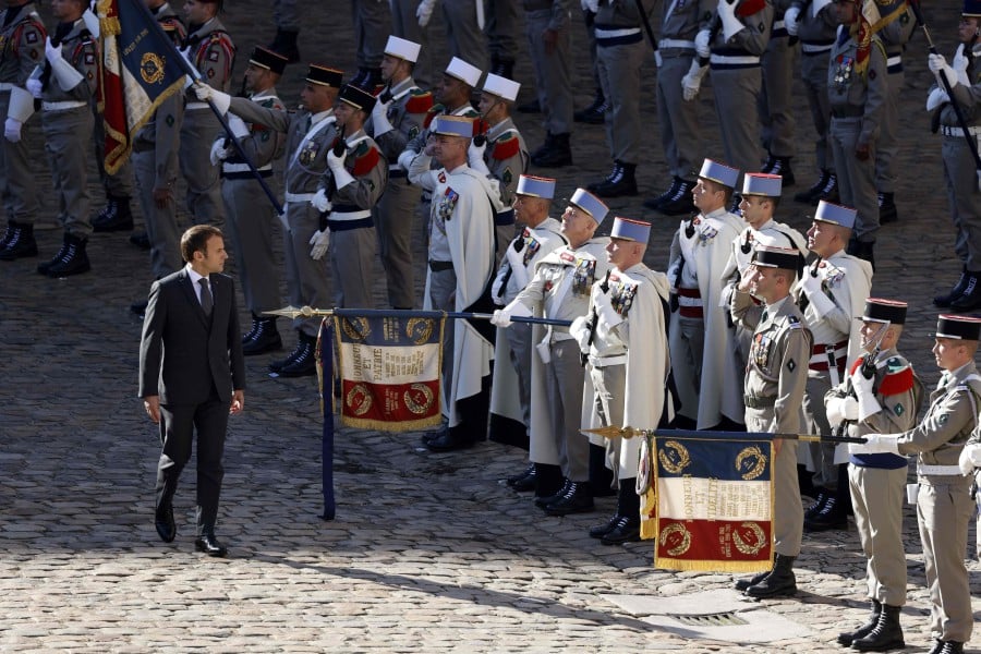 France's President Emmanuel Macron (L) inspects troops including the 1st Spahi Regiment during a ceremony to commemorate the 30th anniversary of Operation Daguet (French operations during the Gulf War - Iraq-Kuwait, 1990-1991), at The Invalides in Paris. - AFP PIC