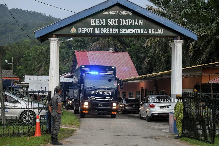 This April 20, 2022, pic shows Immigration Department's trucks seen leaving an Immigration detention depot in Relau, Kedah. - BERNAMA PIC
