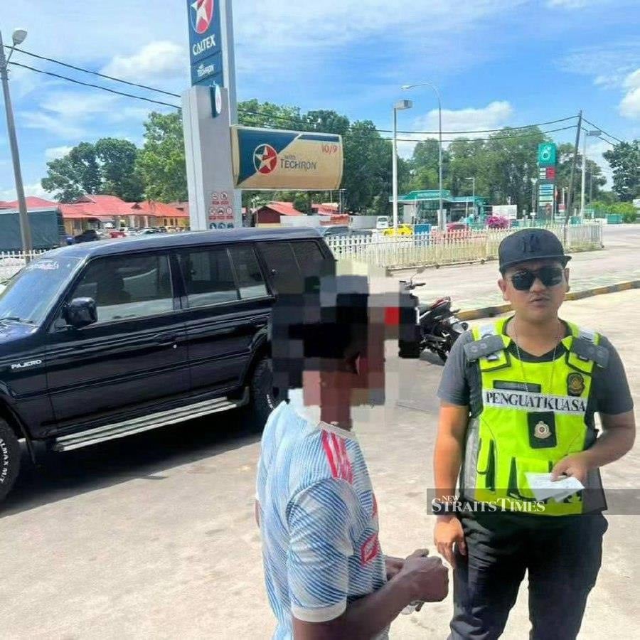 A man in his 30s, caught purchasing diesel repeatedly at a petrol station in Rantau Panjang last week, is suspected to be involved in smuggling activities along the border. - Pic courtesy of Domestic Trade Ministry