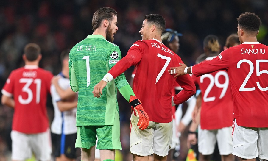 Manchester United's Portuguese striker Cristiano Ronaldo (C right) and Manchester United's Spanish goalkeeper David de Gea (C left) react after the UEFA Champions league group F football match between Manchester United and Atalanta at Old Trafford stadium in Manchester. - AFP PIC