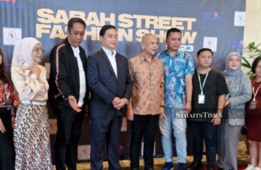 Domestic Trade and Cost of Living (KPDN) minister Datuk Armizan Ali (4th-left) attends the Sabah Street Fashion Show at Sabah International Convention Centre. -NSTP/Olivia Miwil.