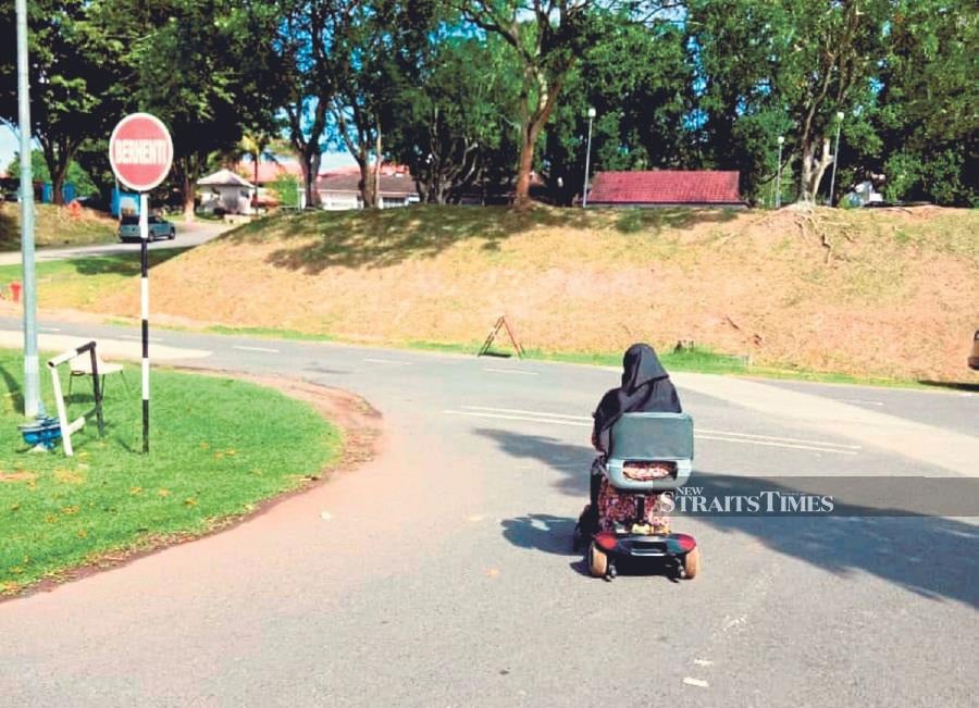 A student with disability using a mobility scooter at a university campus. Enabling individuals with disabilities to access higher education is a shared responsibility. - file pic