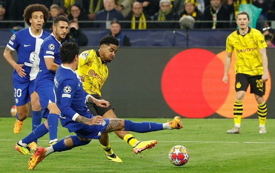 Dortmund's Dutch defender Ian Maatsen scores the 2-0 goal with his team-mates during the UEFA Champions League quarter-final second leg football match between Borussia Dortmund and Atletico Madrid in Dortmund, western Germany. (Photo by Odd ANDERSEN / AFP)
