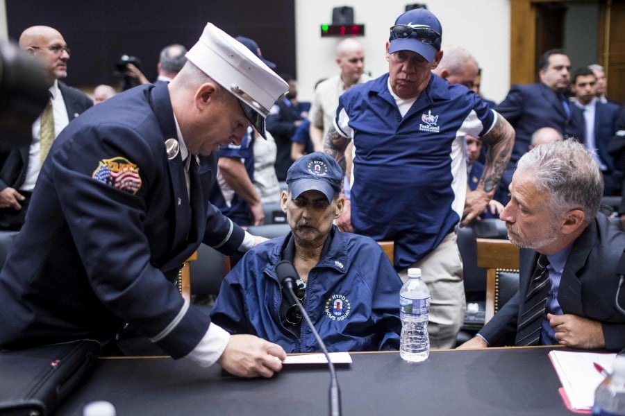 (In this file photo taken on June 11, 2019, Retired Fire Department of New York Lieutenant and 9/11 responder Michael O'Connell (left), FealGood Foundation co-founder John Feal (centre-right) and former Daily Show Host Jon Stewart (right) speak to Retired New York Police Department detective and 9/11 responder Luis Alvarez during a House Judiciary Committee hearing on reauthorization of the September 11th Victim Compensation Fund on Capitol Hill in Washington. - AFP