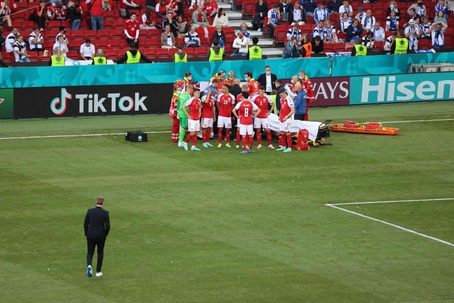 Denmark's players gather as paramedics attend to midfielder Christian Eriksen (not seen) during the UEFA EURO 2020 Group B football match between Denmark and Finland at the Parken Stadium in Copenhagen. -AFP Pic