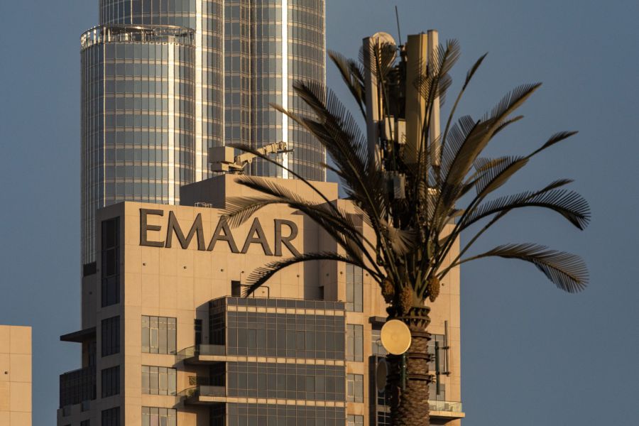 The logo of Emaar Properties PJSC sits on display on the top of a building near the Burj Khalifa skyscraper in Dubai, United Arab Emirates, on Monday, Oct. 12, 2020. Dubai real estate stocks were once the stars for investors betting on the city’s booming economy. But their fall from grace has been spectacular and seems set to continue, given an abundance of unsold homes and scant prospects for a recovery in the oil-rich region. Bloomberg/Photo