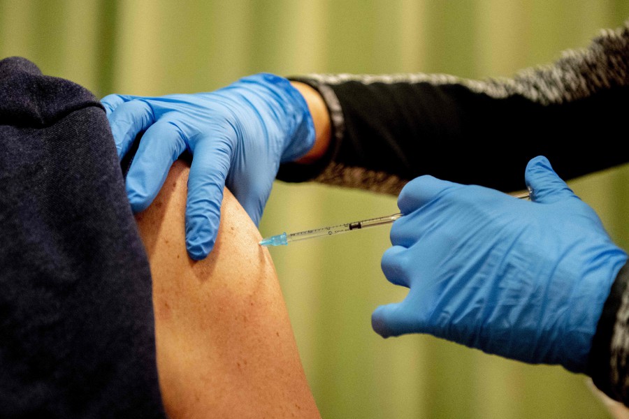 An employee of the Surplus care agency receives a booster shot against coronavirus (Covid-19) at the Elisabeth residential care center in Breda. - AFP PIC