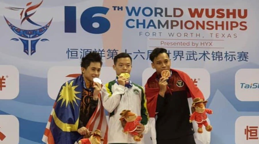 Wong Weng Son (left) on the podium with Macau's Song Chi Kuan (centre) and Indonesia's Mohd Daffa Golden Boy. -- Pic courtesy of Wushu Federation of Malaysia Facebook.
