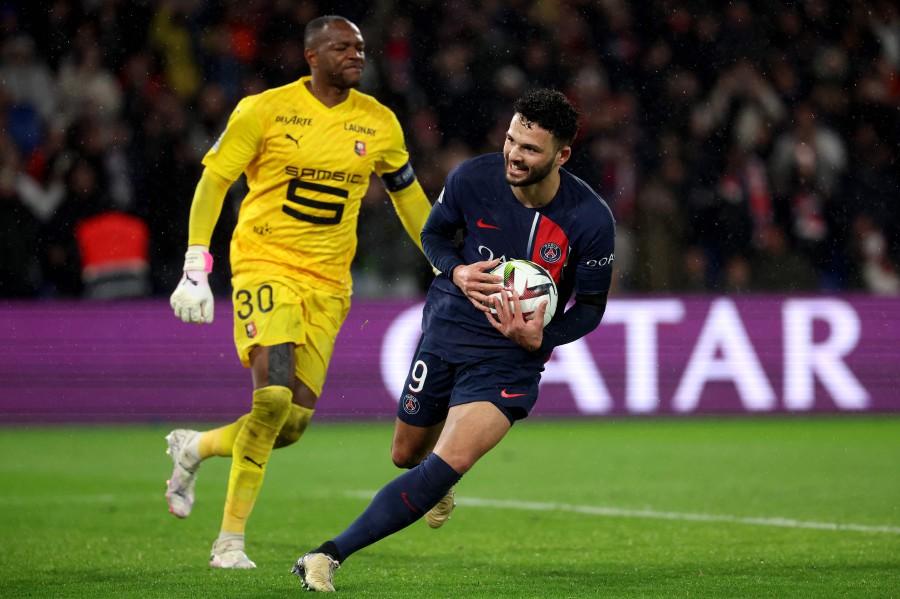 Paris Saint-Germain's Goncalo Ramos (R) celebrates in front of Rennes' French goalkeeper Steve Mandanda (L) after scoring a goal during the match at the Parc des Princes stadium in Paris. - AFP PIC