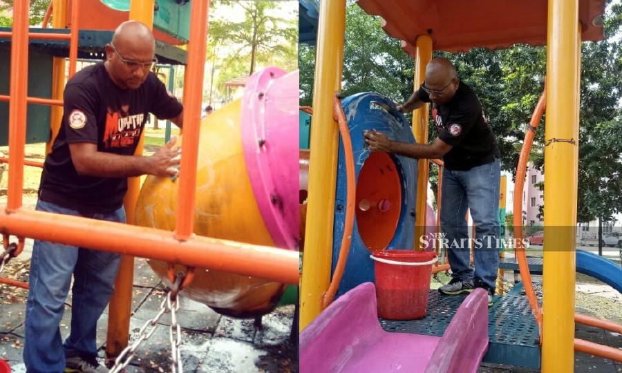 Mustaqim seen cleaning the outdoor playgrounds’ equipment in Bukit Jelutong, in an effort to rid them of possible contamination of the novel coronavirus (2019-nCoV). - Pix source: Facebook/Mustaqim Kumar Abdullah Sooria
